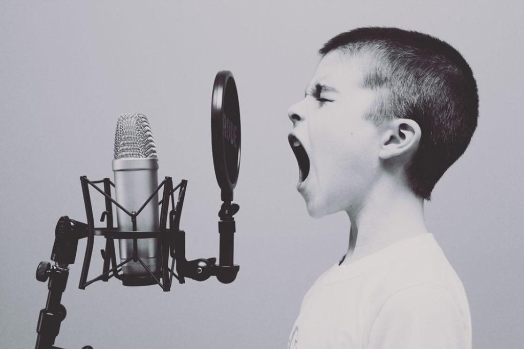 Boy speaking loudly in to a mic